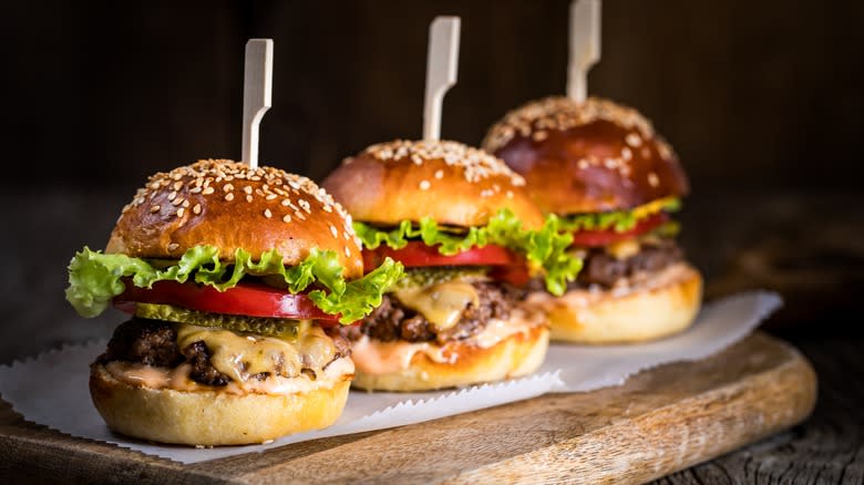 Three slider burgers on table 