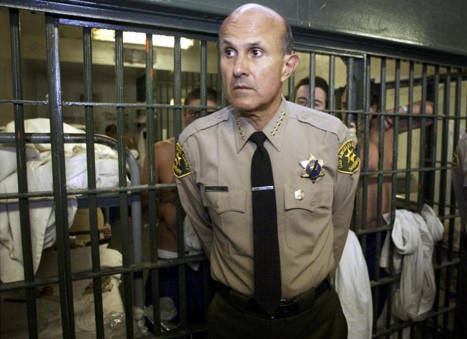 FILE - In this May 19, 2004, file photo, Los Angeles County Sheriff Lee Baca talks with reporters as he leads a tour inside the Men's Central Jail at the Twin Towers Correctional Facility in Los Angeles. Jurors in the federal corruption trial of former Los Angeles County Sheriff Baca have announced Thursday, Dec. 22, 2016, they are hopelessly deadlocked. The judge made the decision Thursday as the jury was in its third day of deliberations. (AP Photo/Damian Dovarganes, File)