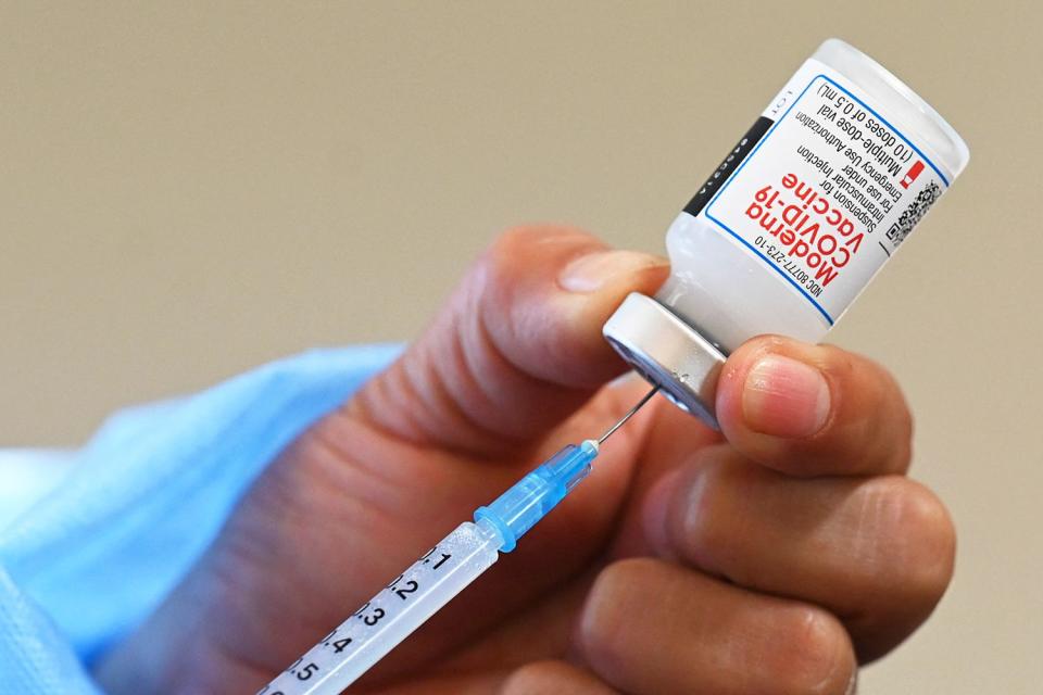 <p>Johan Ordonez/AFP/Getty</p> Nurse prepares COVID-19 vaccination injection