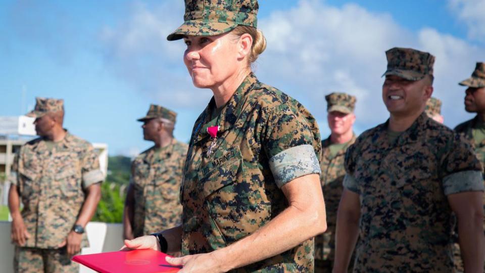 Sgt. Maj. Joy Kitashima holds an award citation during a ceremony at Camp Foster, Okinawa, Japan, on June 23, 2022. (Sgt. Kayla V. Staten/Marine Corps)