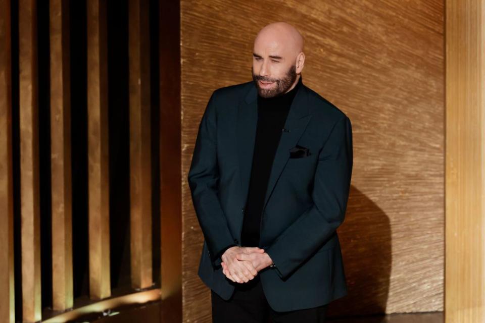 HOLLYWOOD, CALIFORNIA - MARCH 12: John Travolta speaks onstage during the 95th Annual Academy Awards at Dolby Theatre on March 12, 2023 in Hollywood, California. (Photo by Kevin Winter/Getty Images)