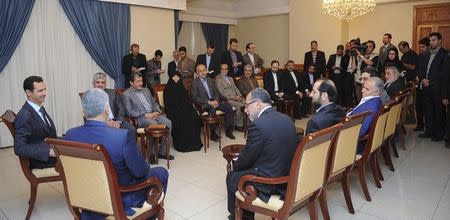 Syria's President Bashar al-Assad (L) meets an Iranian parliamentary delegation headed by Alaeddin Boroujerdi, Chairman of Iranian Parliament's National Security and Foreign Policy Commission (2nd L), in Damascus June 5, 2014, in this handout photograph distributed by Syria's national news agency SANA. REUTERS/SANA/Handout via Reuters