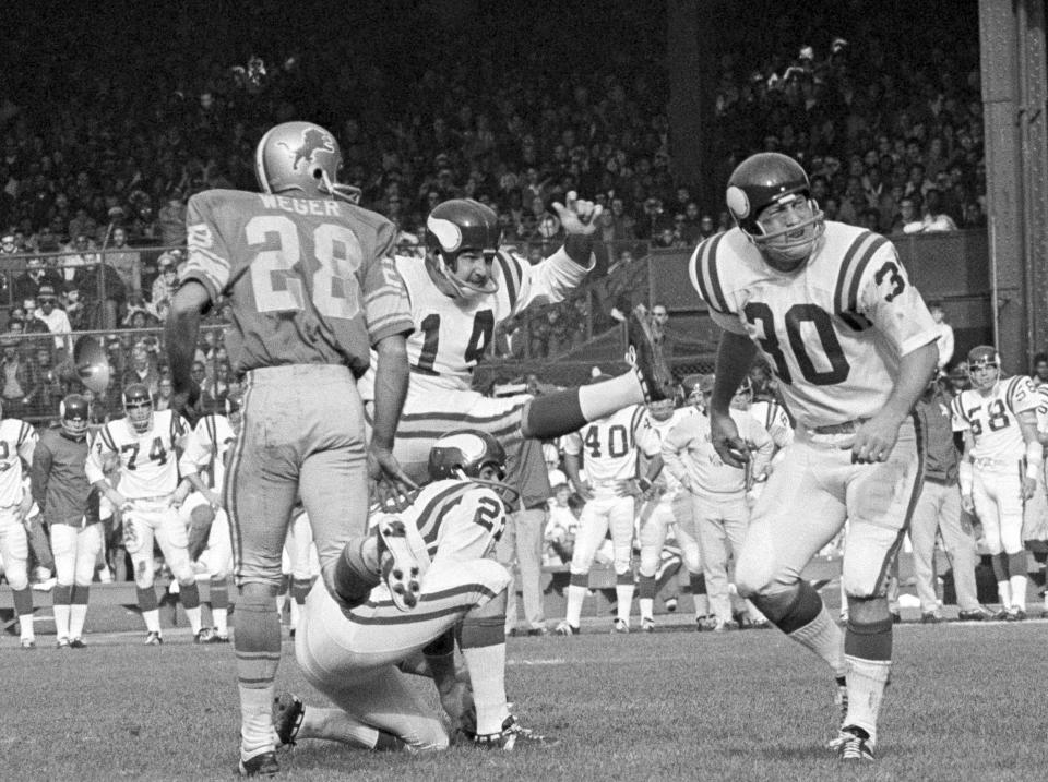 FILE - In this Sunday, Nov. 1, 1970 file photo, Minnesota Vikings Fred Cox (14) kicks a field goal from near the twenty-eight yard line on score three points in first quarter of an NFL football game against the Detroit Lions in Detroit. Fred Cox, the former Minnesota Vikings kicker who co-created the Nerf football, has died. He was 80. The Vikings announced Cox’s death Thursday, Nov. 21, 2019. (AP Photo/File)