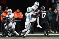 Miami Dolphins safety Jevon Holland (8) intercepts a Hail Mary pass against the New York Jets during the second quarter of an NFL football game, Friday, Nov. 24, 2023, in East Rutherford, N.J. Holland ran back the pass for a touchdown. (AP Photo/Noah K. Murray)