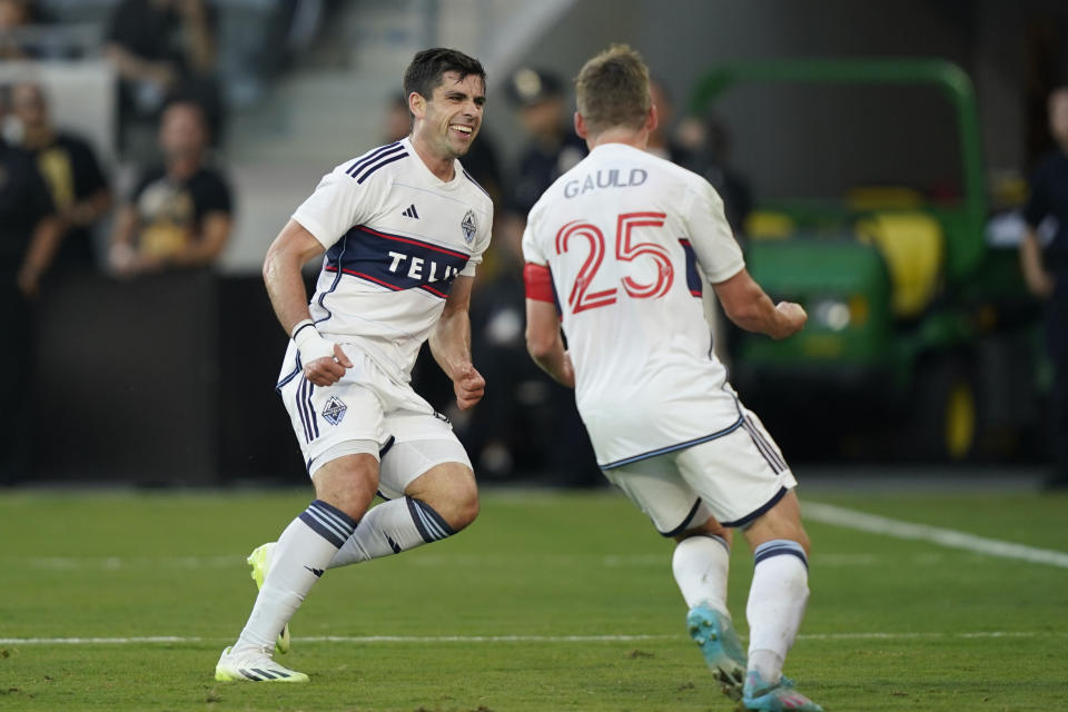 Vancouver Whitecaps forward Brian White, left, celebrates his goal against Los Angeles FC with midfielder Ryan Gauld during the first half of an MLS playoff soccer match Saturday, Oct. 28, 2023, in Los Angeles. (AP Photo/Ryan Sun)