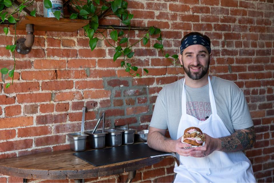 Owner Andrew Vermilyea of The Speakeatery in Asbury Park with The Turk Diggler, a sandwich of smoked turkey, bacon gravy, garlic Parmesan mashed potatoes and cranberry aioli on housemade stuffing buns.