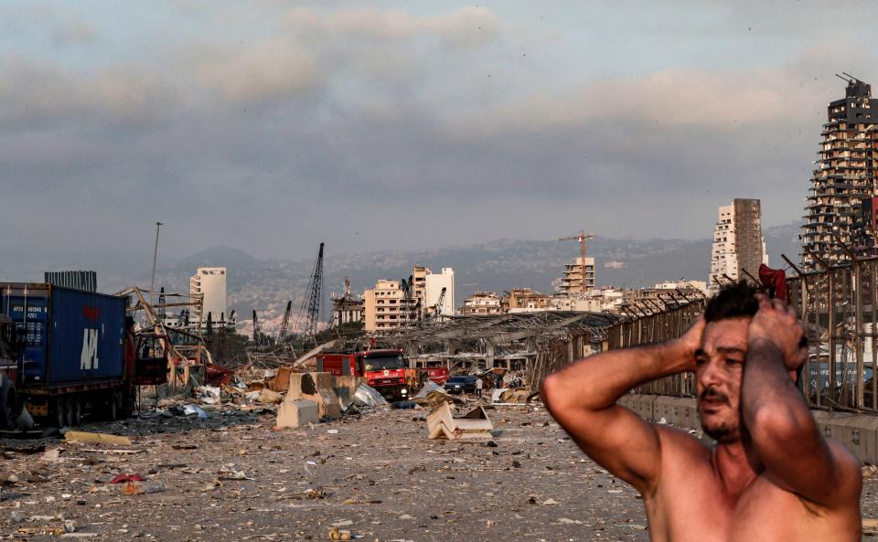 A man reacts at the scene of an explosion at the port in Lebanon's capital Beirut on August 4, 2020. - Two huge explosion rocked the Lebanese capital Beirut, wounding dozens of people, shaking buildings and sending huge plumes of smoke billowing into the sky. Lebanese media carried images of people trapped under rubble, some bloodied, after the massive explosions, the cause of which was not immediately known. (Photo by IBRAHIM AMRO / AFP) (Photo by IBRAHIM AMRO/AFP via Getty Images)