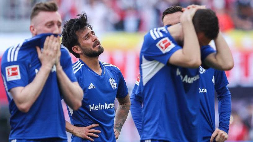 Schalke players look dejected as they stare into the stands 