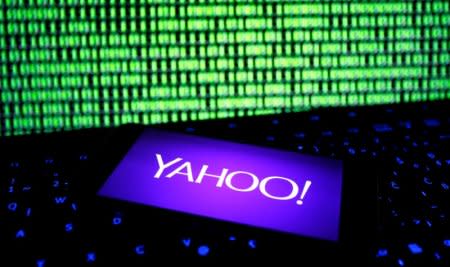 A photo illustration shows a Yahoo logo on a smartphone in front of a displayed cyber code and keyboard on December 15, 2016. REUTERS/Dado Ruvic/Illustration