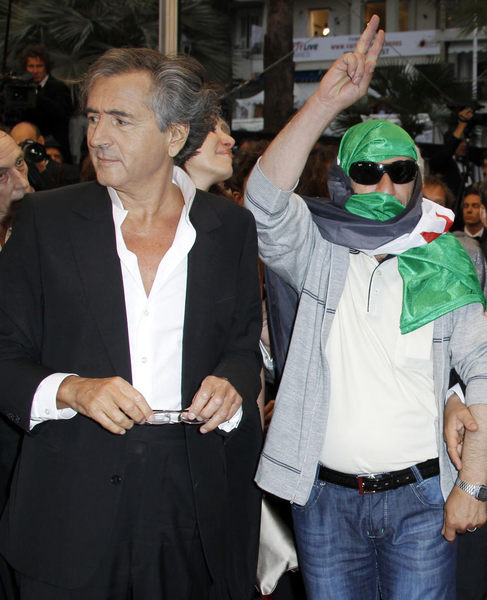 Director Bernard-Henry Levy, left, arrives for the screening of The Oath of Tobruk at the 65th international film festival, in Cannes, southern France, Friday, May 25, 2012. (AP Photo/Joel Ryan)