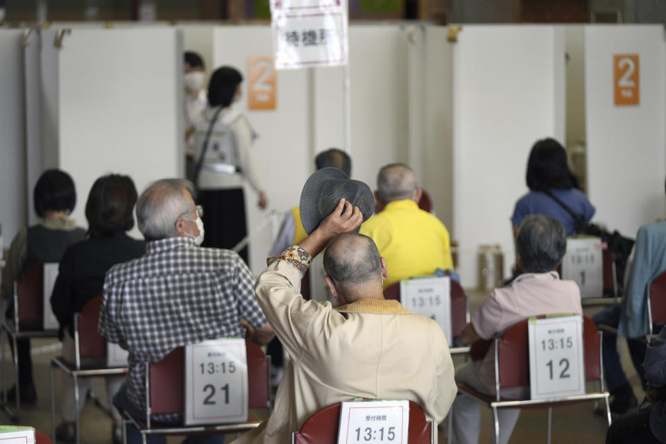 Elderly residents of Sumida Ward wait at the standby station to receive their first dose of Pfizer's COVID-19 vaccine at the Ryogoku Kokugikan sporting arena, in Tokyo on Monday May 24, 2021. The arena, mainly used for sumo wrestling tournaments, is used as temporary inoculation venue for local residents age over 65 years old. (AP Photo/Eugene Hoshiko)