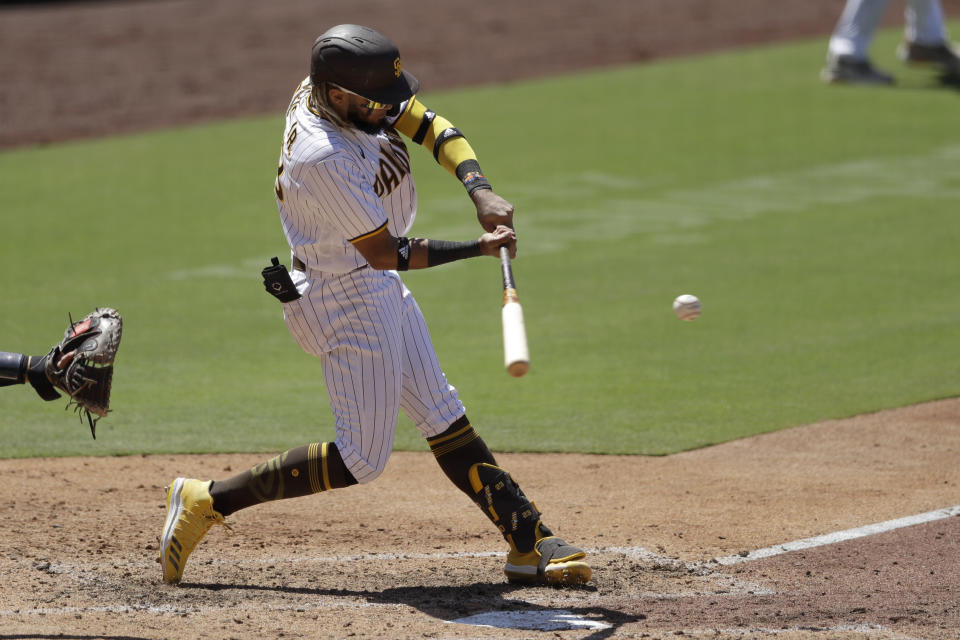 San Diego Padres' Fernando Tatis Jr. hits a three-RBI triple fourth inning of a baseball game against the Arizona Diamondbacks, Monday, July 27, 2020, in San Diego. (AP Photo/Gregory Bull)