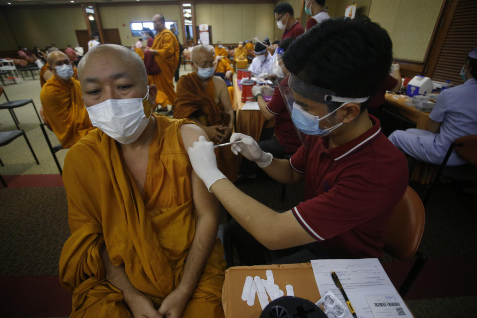 A health worker administers a dose of the Sinovac COVID-19 vaccine to Buddhist monk at Priest Hospital in Bangkok, Thailand Tuesday, May 18, 2021. Thailand had about 7,100 cases, including 63 deaths, in all of last year, in what was regarded as a success story. Taxi drivers are starved for customers, weddings are suddenly canceled, schools are closed, and restaurant service is restricted across much of Asia as the coronavirus makes a resurgence in countries where it had seemed to be well under control. (AP Photo/Anuthep Cheysakron)