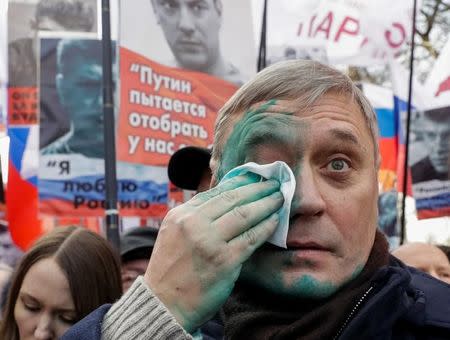 Mikhail Kasyanov, Russian opposition leader, wipes his face after green paint was thrown at him during a rally to mark anniversary of murder of Kremlin critic Boris Nemtsov in Moscow, Russia, February 26, 2017. REUTERS/Tatyana Makeyeva