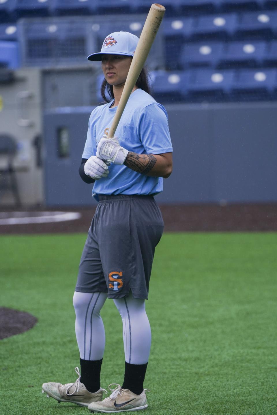 Kelsie Whitmore, a 23-year-old two-way player for the Atlantic League's Staten Island FerryHawks, waits for her turn in the batting cage, Friday, May 13, 2022, in New York. Whitmore is one of the first women to be in the starting lineup and pitch relief with a professional team connected to Major League Baseball. (AP Photo/Bebeto Matthews)