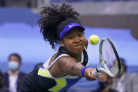 FILE - In this Sept. 12, 2020, file photo, Naomi Osaka, of Japan, returns a shot to Victoria Azarenka, of Belarus, during the women's singles final of the US Open tennis championships, in New York. Osaka's victory in the U.S. Open helped raised the issue of racial injustice in the United States. Before each of her matches, she wore a mask with the names of seven Black Americans who died as victims of violence. The daughter of a Japanese mother and Haitian father, she has become a leader of the Black Lives Matter movement. (AP Photo/Seth Wenig, File)