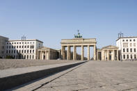 There are almost no visitors at the Pariser Platz in front of the Brandenburg Gate in Berlin, Germany, Tuesday, April 7, 2020. In order to slow down the spread of the coronavirus, the German government has considerably restricted public life. The new coronavirus causes mild or moderate symptoms for most people, but for some, especially older adults and people with existing health problems, it can cause more severe illness or death. (Christophe Gateau/dpa via AP)