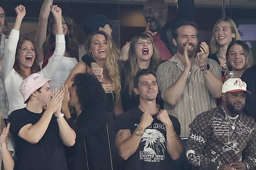 Taylor Swift, top center, Blake Lively, second from left, and Ryan Reynolds, react during an NFL football game