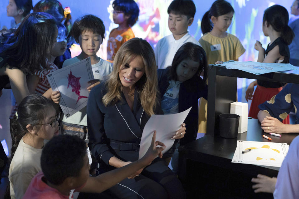 U.S. first lady Melania Trump talks with children during a visit to a digital art museum in Tokyo Sunday, May 26, 2019. (Pierre-Emmanuel Deletree/Pool Photo via AP)