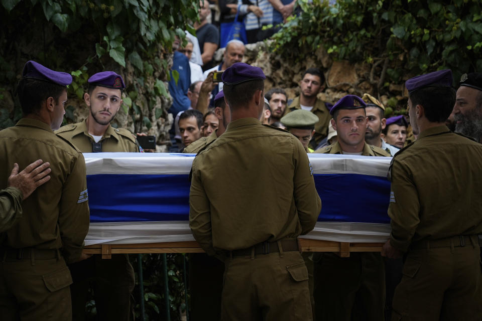 Israeli soldiers carry the flag-draped casket of Staff Sgt. Lavi Lipshitz during his funeral in the Mount Herzl Military Cemetery in Jerusalem, Wednesday, Nov. 1, 2023. Lipshitz was killed during a ground operation in the Gaza Strip. Israeli ground forces have been operating in Gaza in recent days as Israel presses ahead with its war against Hamas militants. (AP Photo/Ohad Zwigenberg)