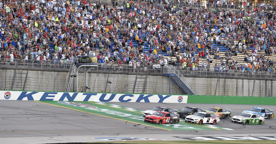 Daniel Suarez (41) leads the field across the line to start the NASCAR Cup Series auto race at Kentucky Speedway in Sparta, Ky., Saturday, July 13, 2019. (AP Photo/Timothy D. Easley)