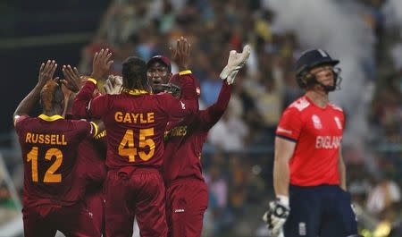 Cricket - England v West Indies - World Twenty20 cricket tournament final - Kolkata, India - 03/04/2016. West Indies players celebrate the dismissal of England's captain Eoin Morgan. REUTERS/Adnan Abidi