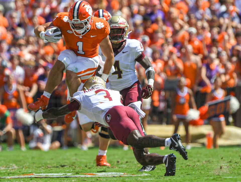 Tigers running back Will Shipley jumps over Seminoles defensive back Kevin Knowles II.