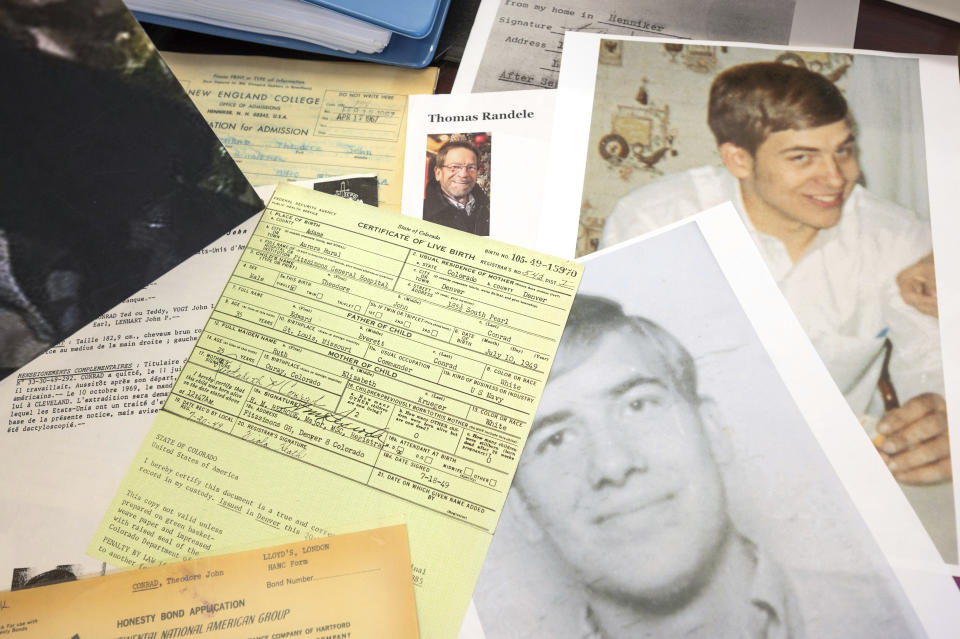 Photos, a driver's license, a death notice and other items from a 1969 robbery involving Ted Conrad are shown on Dec. 16, 2021 at the Carl B. Stokes U.S. Courthouse in Cleveland. After more than 50 years, Elliott announced that they had closed the case on one the city's biggest bank robberies. Conrad pulled off the 1969 robbery and had been living in Boston under a new name until his death last May, Elliott said. The U.S. Marshals Service is now piecing together how he managed to create new life while evading authorities. His stunned friends in Boston say he was a devoted family man and one of the nicest and most honorable people they'd ever known. (AP Photo/Ken Blaze)