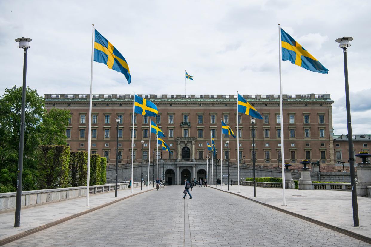 Swedish flags fly in front of the Royal Palace in Stockholm on May 29, 2020, amid the coronavirus COVID-19 pandemic. - Sweden's two biggest opposition parties called Friday for an independent commission to be appointed within weeks to probe the country's response to the new coronavirus. (Photo by Jonathan NACKSTRAND / AFP) (Photo by JONATHAN NACKSTRAND/AFP via Getty Images)