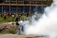 <p>Supporters of Kenyan opposition National Super Alliance (NASA) coalition, run as riot police officers fire tear gas to disperse them along Mombasa Road, Kenya, Nov. 17, 2017. (Photo: Baz Ratner/Reuters) </p>