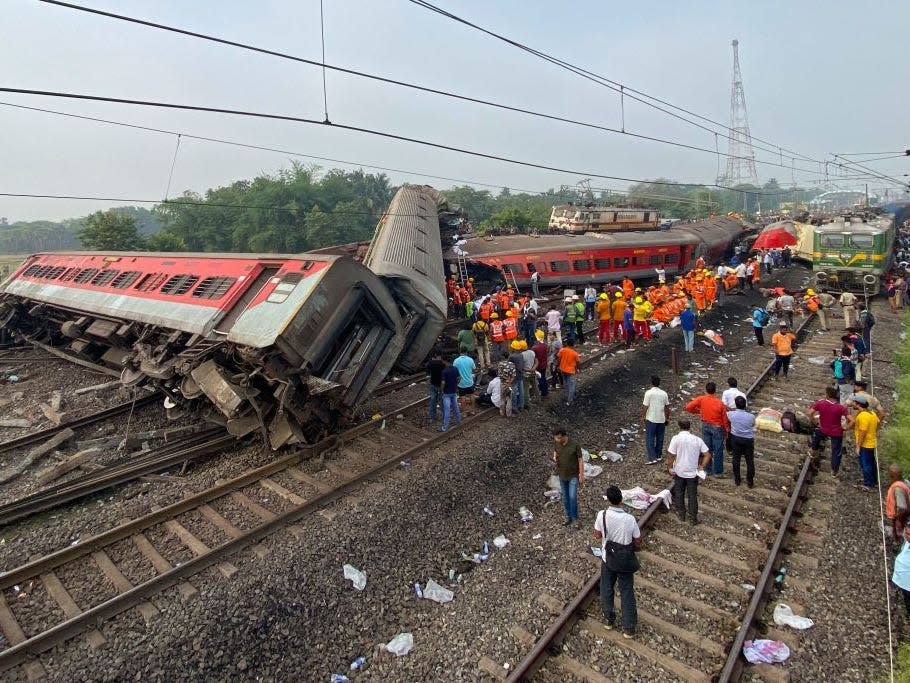 People gather at the accident site of a three-train collision near Balasore, about 200 km (125 miles) from the state capital Bhubaneswar, on June 3, 2023.