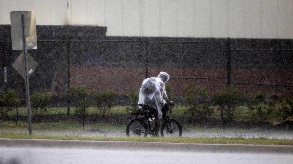 A cyclists braves torrential rain on Westinghouse Boulevard in Raleigh during a severe thunderstorm that swept through the Triangle on Tuesday afternoon, Aug 15, 2023. Travis Long/tlong@newsobserver.com