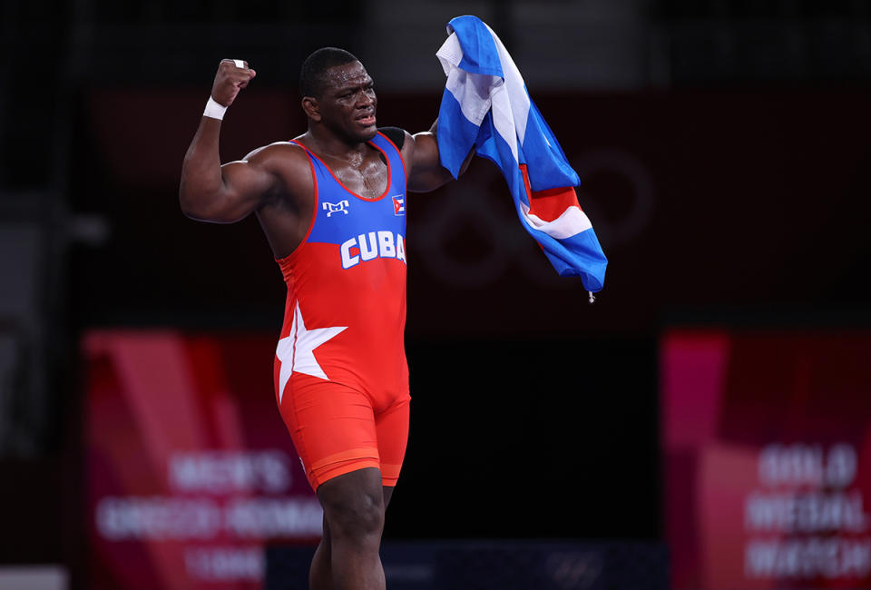 <p>Cuba's Mijain Lopez Nunez raises his arms in triumph after defeating Georgia's Iakobi Kajaia in the men's greco-roman 130kg wrestling final match at the Makuhari Messe on August 2.</p>