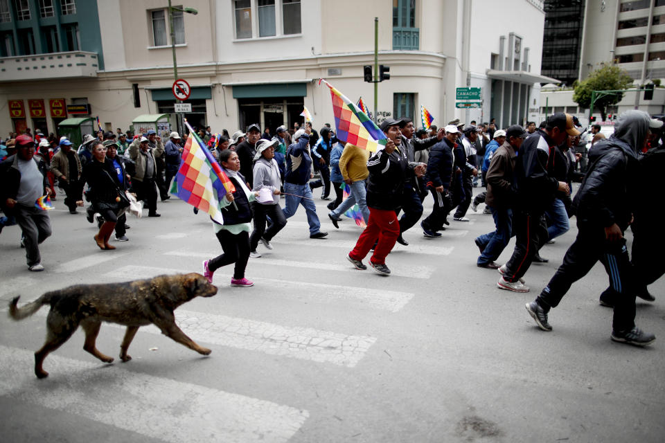 Backers of former President Evo Morales march in La Paz, Bolivia, Wednesday, Nov. 13, 2019. Bolivia's new interim president Jeanine Anez faces the challenge of stabilizing the nation and organizing national elections within three months at a time of political disputes that pushed Morales to fly off to self-exile in Mexico after 14 years in power. (AP Photo/Natacha Pisarenko)