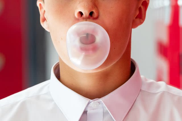 <p>Getty</p> male teenager blowing a bubble with bubble gum -- stock image