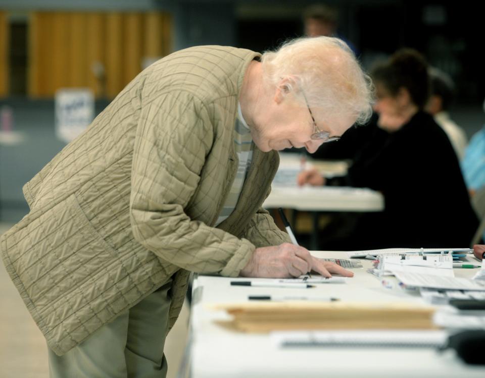 Marilyn Tisckos signs her signature to get her ballot on election day at the Knights of Columbus on West Street Tuesday, April 4, 2023. 