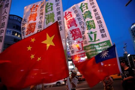 Members of a Taiwanese independence group march with flags around the group of pro-China supporters holding a rally calling peaceful reunification, in Taipei, Taiwan May 14, 2016. REUTERS/Tyrone Siu/Files