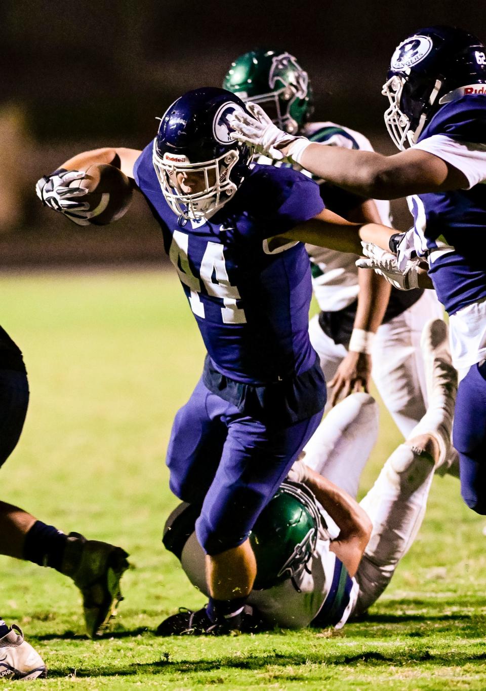 Redwood's Jacob Florez fights for yardage against El Diamante in an East Yosemite League high school football game Friday, September 30, 2022.