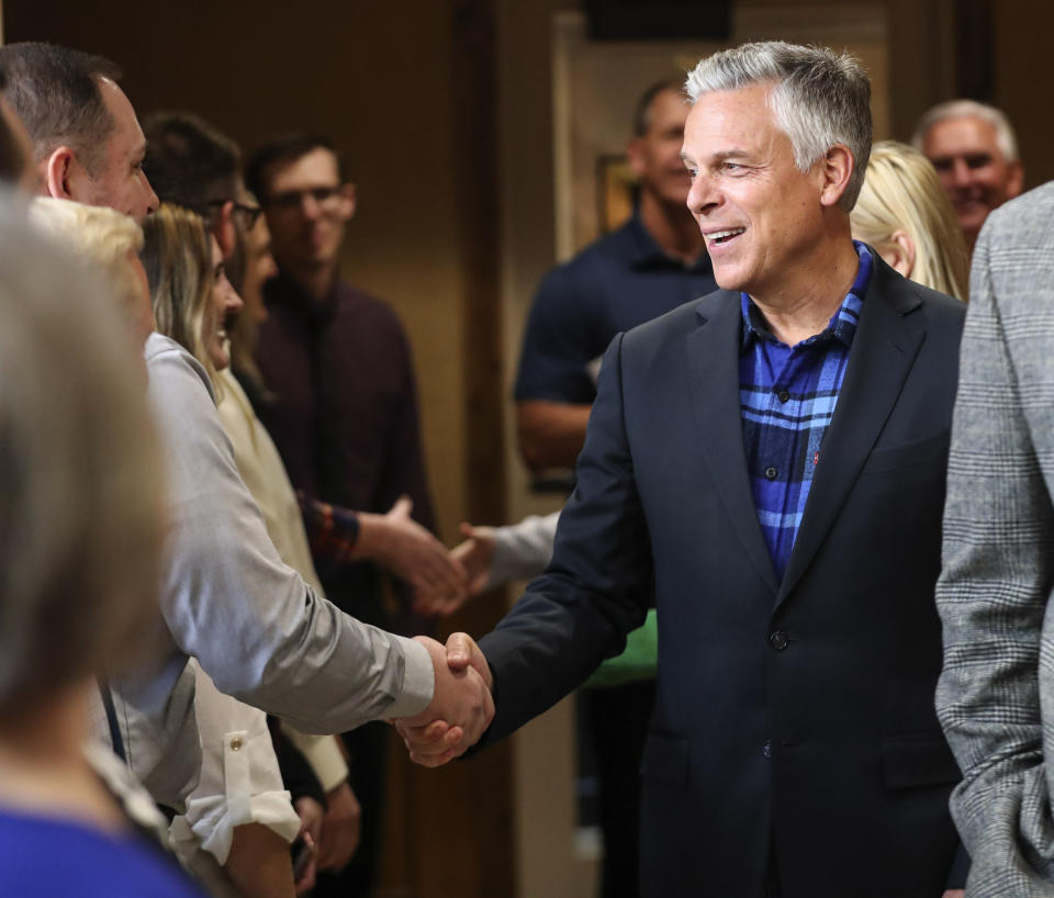 Jon Huntsman Jr. talk with employees and clients at KKOS Lawyers and K&E CPAs in their offices in Cedar City, Utah, shortly after announcing that he is running for a third term as Utah's governor Thursday, Nov. 14, 2019. (Steve Griffin/The Deseret News via AP)