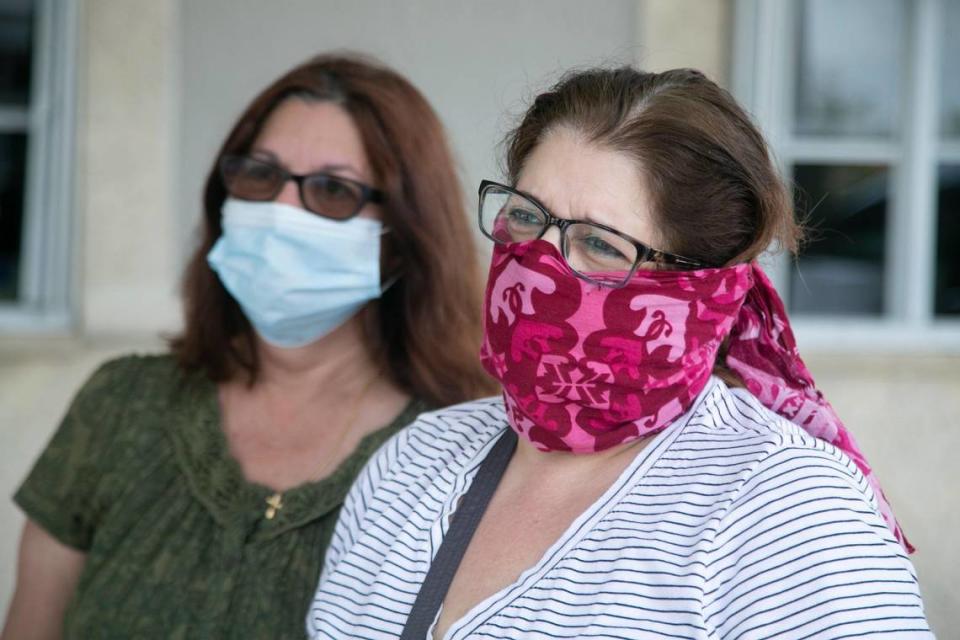 Ana Batista Marrero, left, and Ada Batista Palenzuela visit Vior Funeral Home as they seek funeral services for their mother under today’s COVID-19 restrictions on Tuesday, April 21, 2020.