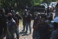 Members of the so-called self-defense group known as United Towns or Pueblos Unidos, gather for a rally in Nuevo Urecho, in the Mexican western state of Michoacan, Saturday Nov. 27, 2021. Extortion of avocado growers in western Mexico has gotten so bad that 500 vigilantes from the "self-defense" group gathered Saturday and pledged to aid police. (AP Photo/Armando Solis)