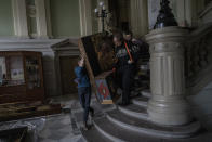 Workers move a baroque sacred art piece in the Andrey Sheptytsky National Museum as part of safety preparations in the event of an attack in the western Ukrainian city of Lviv, Friday, March 4, 2022. The doors of the museum have been closed since Russia’s war on Ukraine began on Feb. 24, and heritage sites across the country face danger as the fighting continues. (AP Photo/Bernat Armangue)