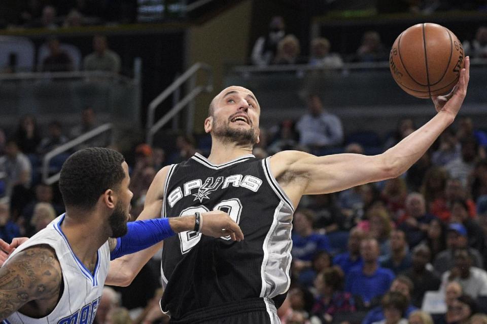 FILE - In this Wednesday, Feb. 15, 2017, file photo, San Antonio Spurs guard Manu Ginobili (20) grabs a rebound in front of Orlando Magic guard D.J. Augustin during the first half of an NBA basketball game in Orlando, Fla. Teams, and the league, try to make the transition to the NBA easier for all players, but internationals need some special attention. Ginobili, the veteran Spurs guard, said he would get lonely at times when he was younger with a lot fewer international players in the league. (AP Photo/Phelan M. Ebenhack, File)