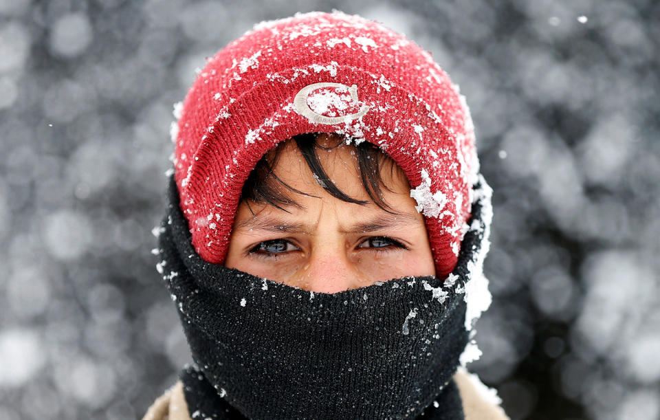 Displaced boy during a snowfall in Kabul