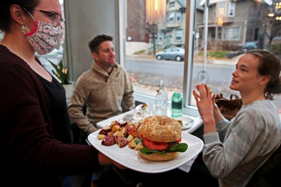 Georgia Garcia serves the Ruby’s bagel sandwich to Mary Kuder, who was having brunch with James Brown at Lafayette Place, 1978 N. Farwell Ave. The vegan restaurant is among the newer spots in and around Milwaukee serving brunch.