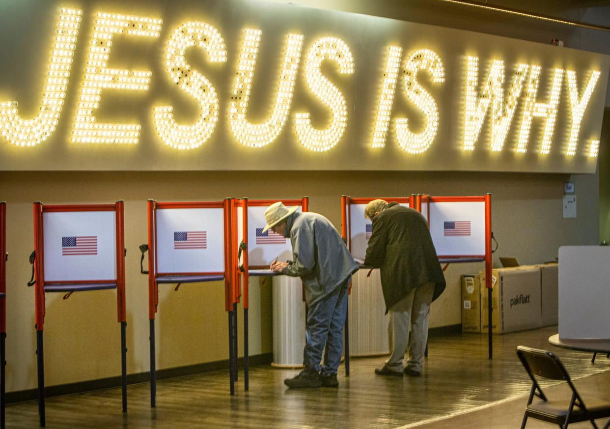 People vote under a Jesus is Why sign at Northeast Christian Church in Louisville on election day. Nov. 8, 2022