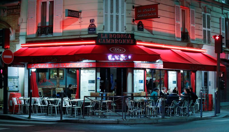 People sit in a outside restaurant, as France's Prime Minister announced to close most all non-indispensable locations, notably cafes, restaurants, cinemas, nightclubs and shops from midnight on Saturday, in Paris