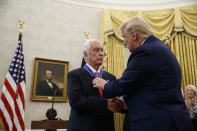 President Donald Trump shakes hands with auto racing great Roger Penske during a Presidential Medal of Freedom ceremony in the Oval Office of the White House, Thursday, Oct. 24, 2019, in Washington. (AP Photo/Alex Brandon)