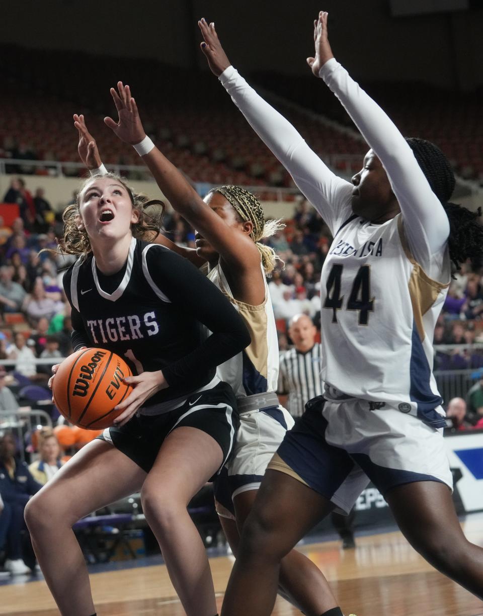 Millennium Tigers’ Elli Guiney (1) looks to shoot the ball over Desert Vista Thunder’s  Shay Ijiwoye (44) during their Open Division State Championship game at Arizona Veterans Memorial Coliseum in Phoenix on March 4, 2023.