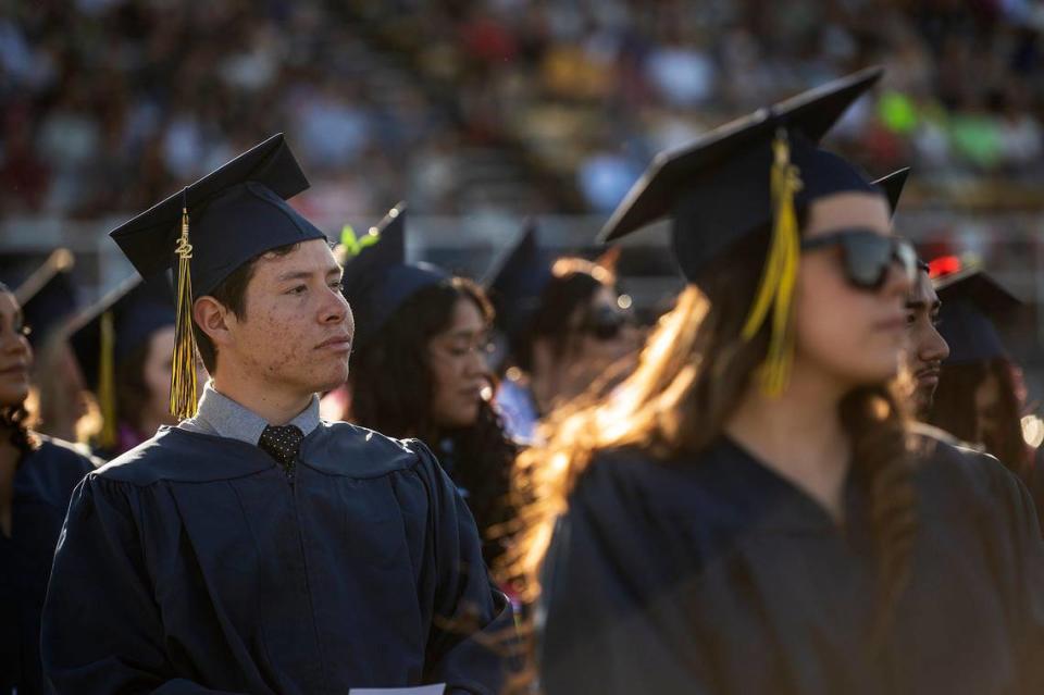 Graduate Mykel Lara, 20, of Los Banos, looks on during a commencement ceremony for the Merced College class of 2022 on the Don Odishoo Field at Stadium ’76 in Merced, Calif., on Friday, May 20, 2022.